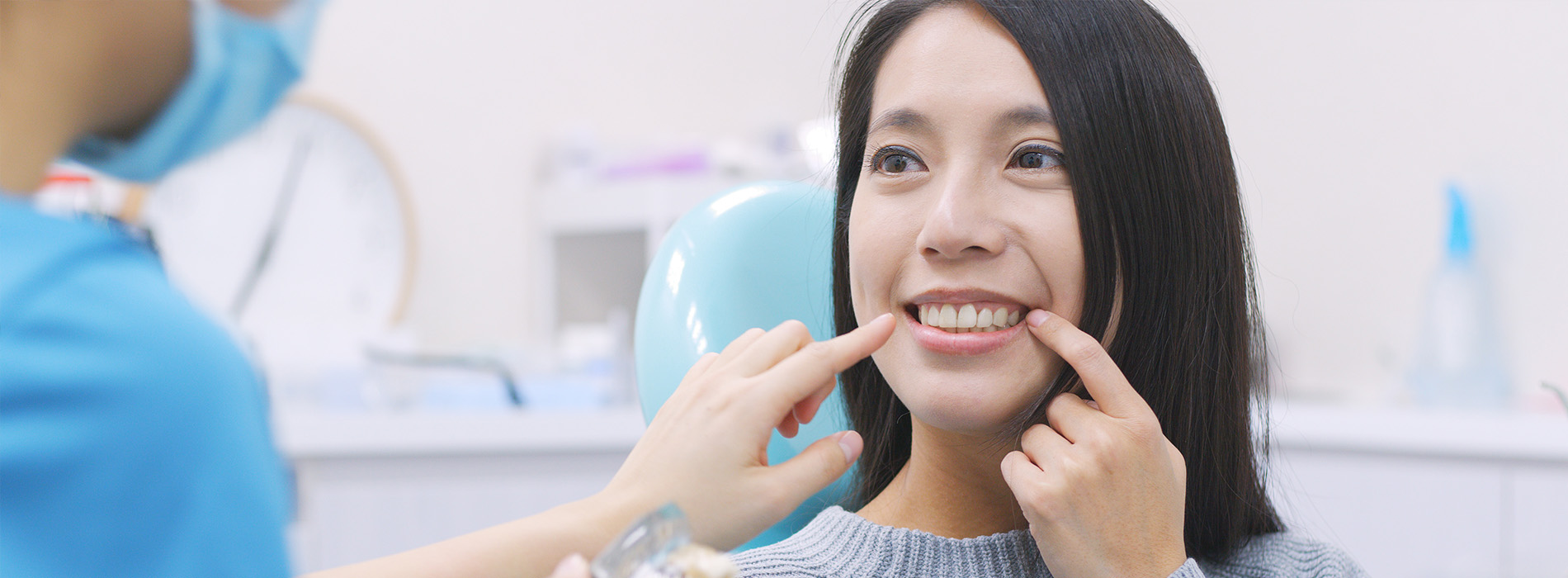 A woman receiving dental care with a smile on her face.