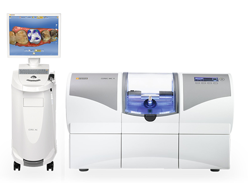 The image shows a collection of high-tech equipment, including a large 3D printer, an industrial machine with a digital display, a smaller device resembling an oven or incubator, and a monitor displaying a blue screen with some kind of graphical interface. These items are arranged in a way that suggests they are part of a technology center or lab setup.