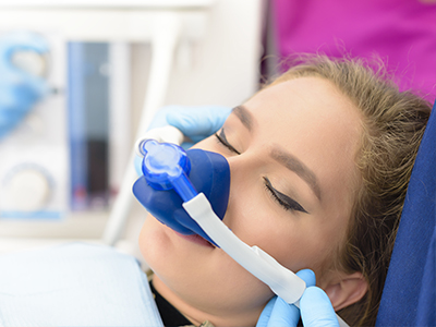 Woman receiving oxygen therapy with medical equipment.
